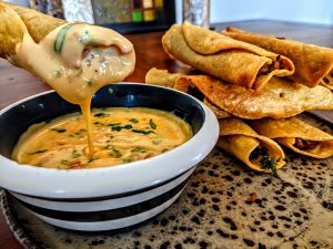 Dirty Rice Stuffed Taquitos with Creole Cheese Dip